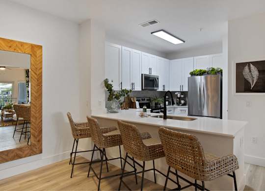 an open kitchen with a large island with bar stools