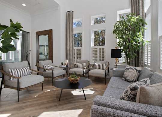 a living room with a couch and chairs and a table