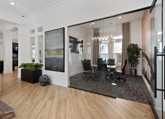 a conference room with glass walls and a table and chairs