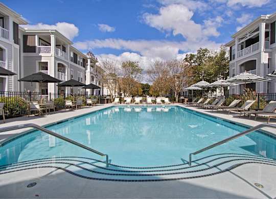 a swimming pool in front of an apartment building