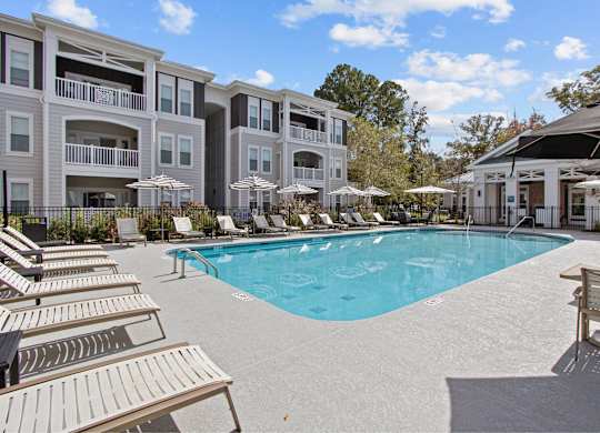 a large swimming pool in front of an apartment building