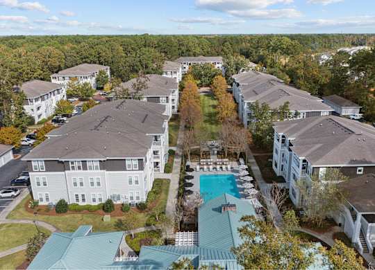 an aerial view of a neighborhood of houses with a swimming pool