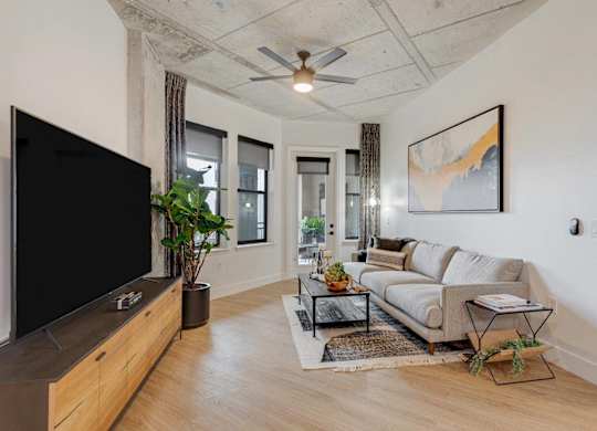 A living room with a flat screen TV and a couch.