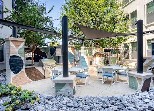 A patio with a table and chairs under a canopy.