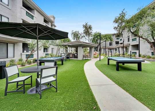 picnic area with tables chairs and umbrellas