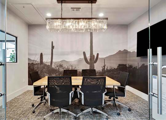 a mural of a desert landscape is painted on the wall of this conference room