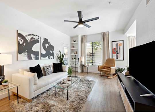 a living room with a white couch and a large window