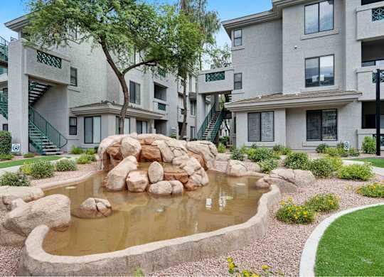 a pond sits in the middle of an apartment complex