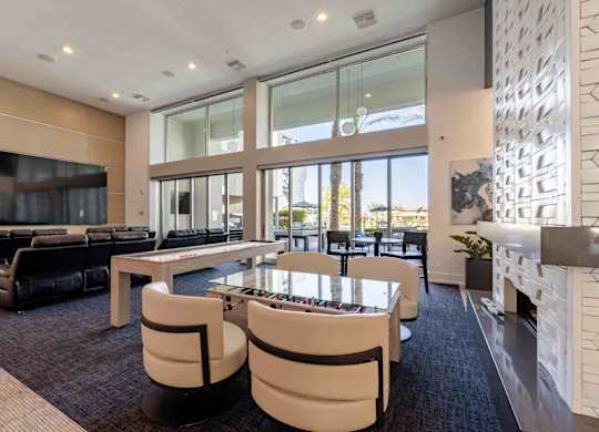 a game room with a foosball table and chairs