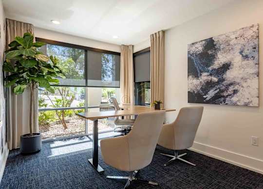 desk and chairs in conference room at slate scottsdale apartments