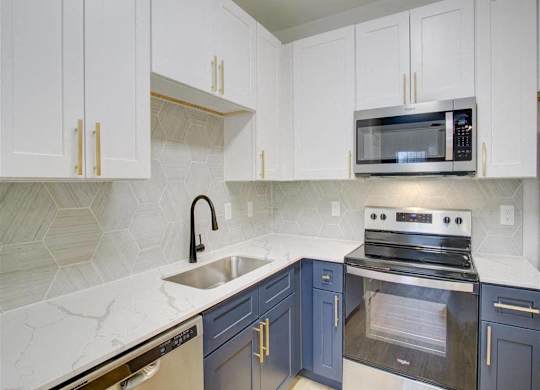 A kitchen with a white counter top and a black oven.
