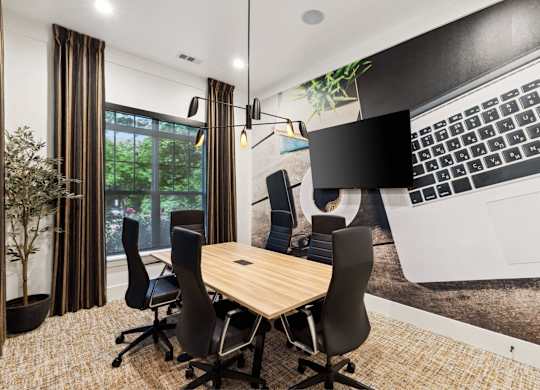 A conference room with a large table and chairs.