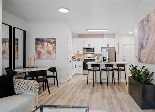 A modern kitchen with a dining table and chairs.