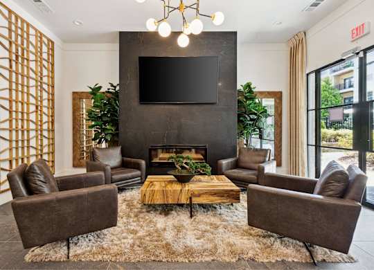 A living room with a fireplace and a flat screen TV mounted on the wall.