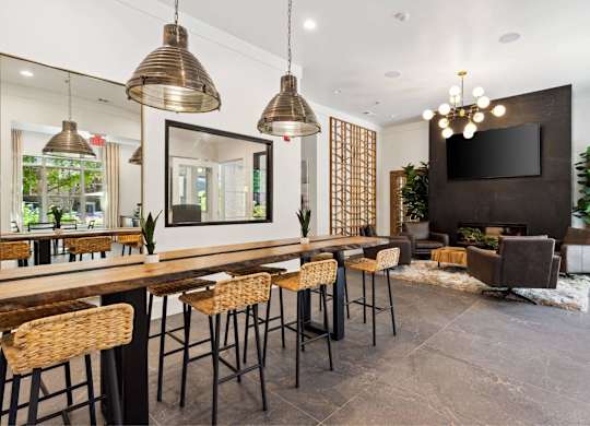 A modern dining area with a long table and chairs.
