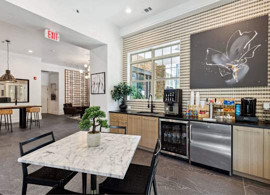A modern kitchen with a marble table and a bamboo wall.