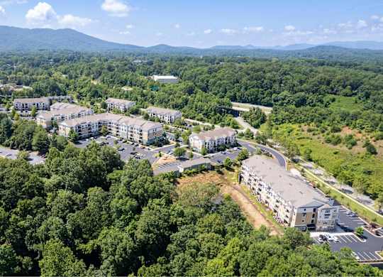 A bird's eye view of a resort surrounded by trees.