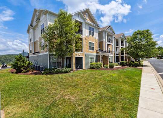 A large apartment complex with multiple buildings and green lawns.