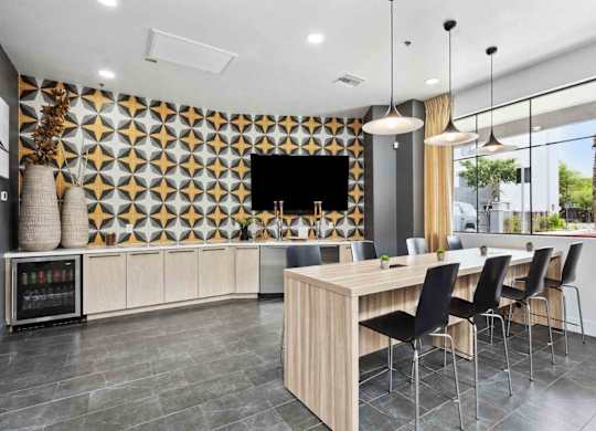 A modern kitchen with a wooden table and chairs.