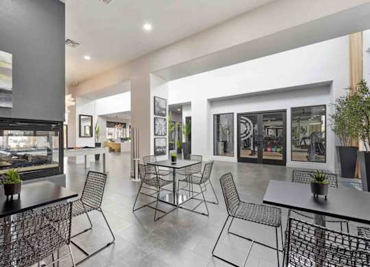 A modern dining area with a glass wall and a view of the outside.