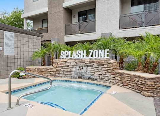 A pool with a sign that says splash zone.