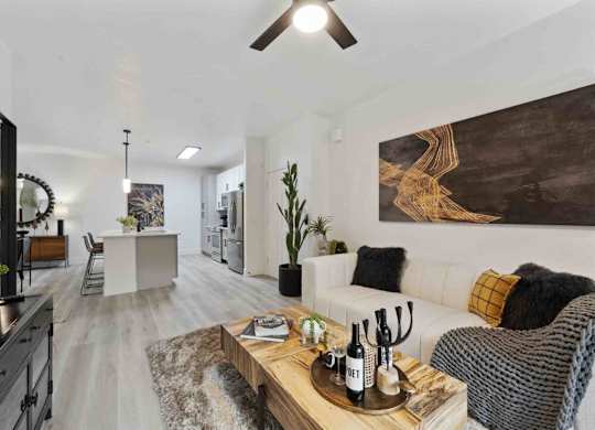 A modern living room with a white couch and a wooden coffee table.