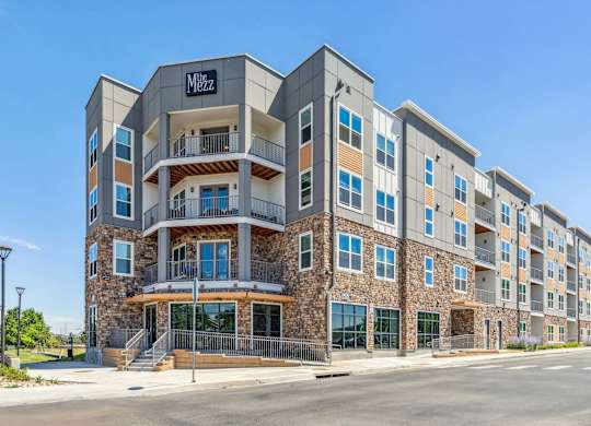a large apartment building with a street in front of it