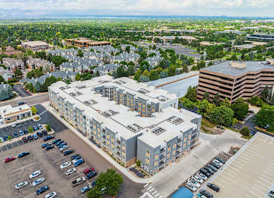 a large white building with a parking lot in front of it