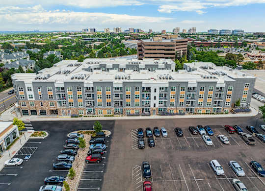 an aerial view of a large building with a parking lot in front of it