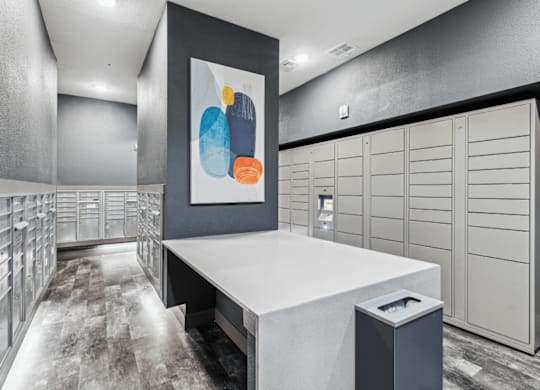 a spacious package locker with white cabinets and a colorful painting on the wall