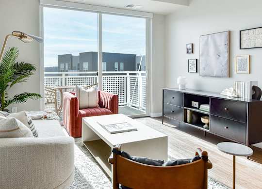 a living room with furniture and a large window at The Hallon Apartments, Minnesota, 55343