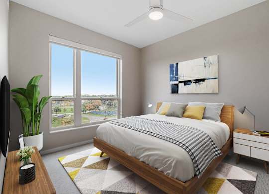 bedroom with queen bed and ample natural light at The Hallon Apartments, Hopkins, Minnesota