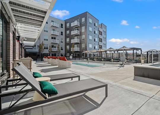 pool with lounge chairs at The Hallon Apartments, Hopkins, Minnesota