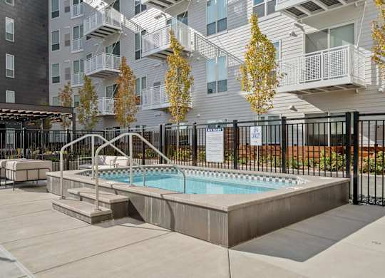 Luxury Studio Apartments Hopkins MN  - The Hallon - Hot Tub/Spa with Nearby Patio Furniture, and Maintained Landscaping