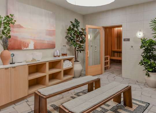 A room with a wooden bench and a painting on the wall.
