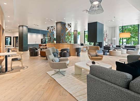 A modern living room with a grey sofa and a wooden floor.