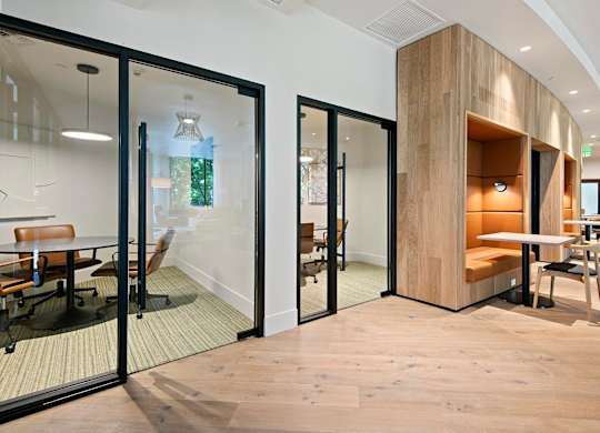 A modern office space with glass walls and wooden accents.