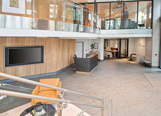 A modern living room with a television and a balcony.