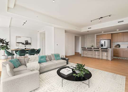 A modern living room with a white sofa and a coffee table.