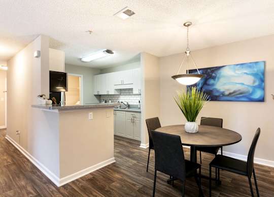 Furnished dining area with table and chairs at Aqua Sandy Springs apartments.