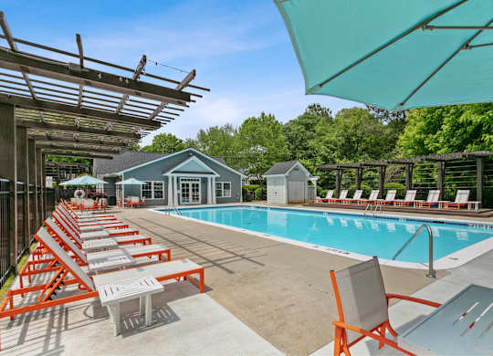 Pool with sun loungers at Aqua Sandy Springs apartments for rent in Sandy Springs, GA.