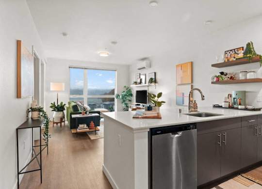 A modern kitchen with a large island and stainless steel appliances.