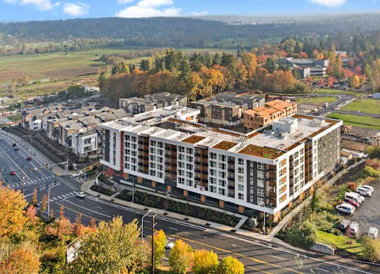 A large building with a parking lot in front of it.