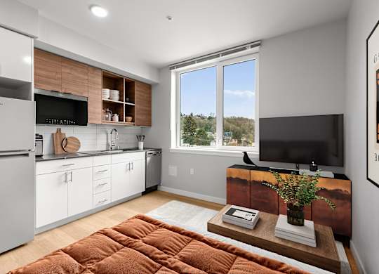 A modern kitchen with white cabinets and a wooden countertop.