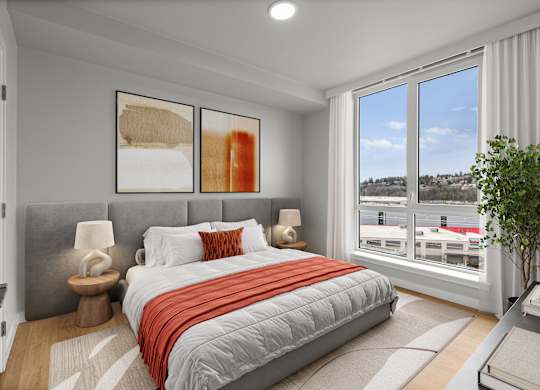 A bedroom with a large bed and a view of the city.