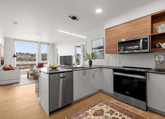 A modern kitchen with a large island and stainless steel appliances.