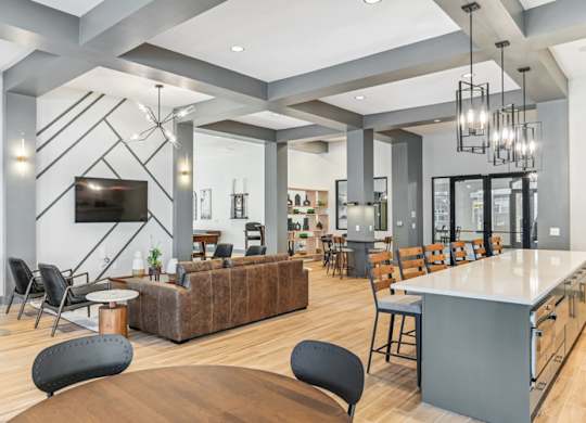 A modern living room with a wooden floor and a large TV mounted on the wall.