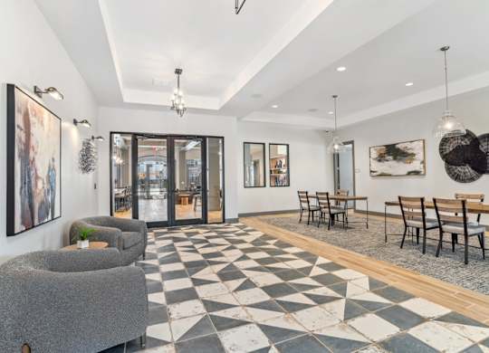 A black and white checkered floor in a room with a dining table and chairs.