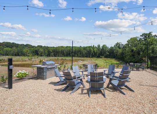 A set of chairs are arranged on a gravel area.