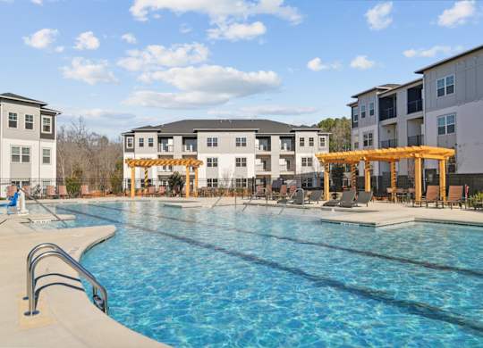 A swimming pool in front of apartment buildings.